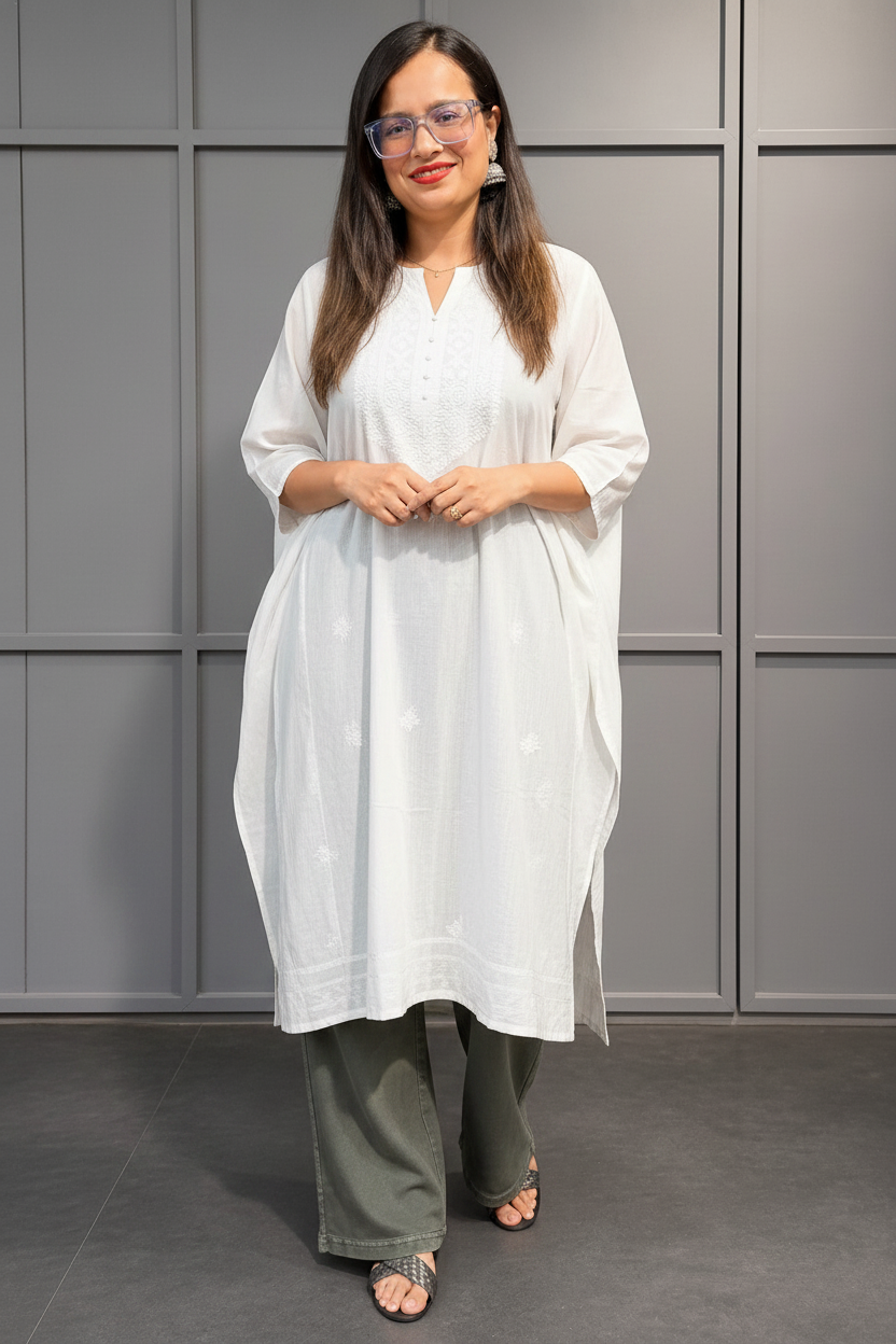 Woman wearing green wide leg denim pant styled with white kurta