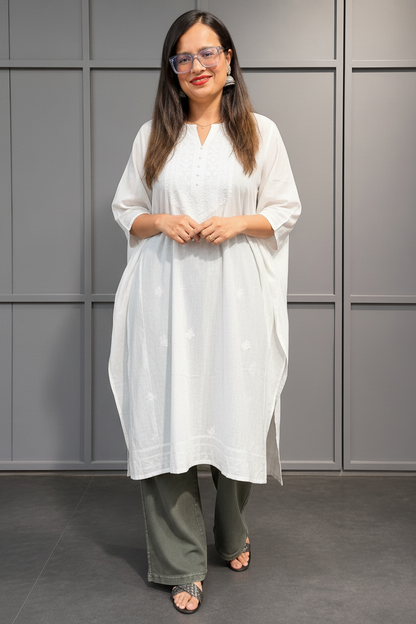 Woman wearing green wide leg denim pant styled with white kurta