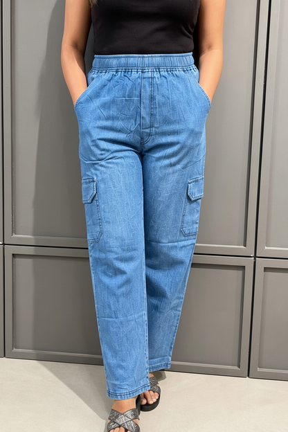 Close-up waist to ankle shot of blue denim cargo pant showing cargo pocket detail