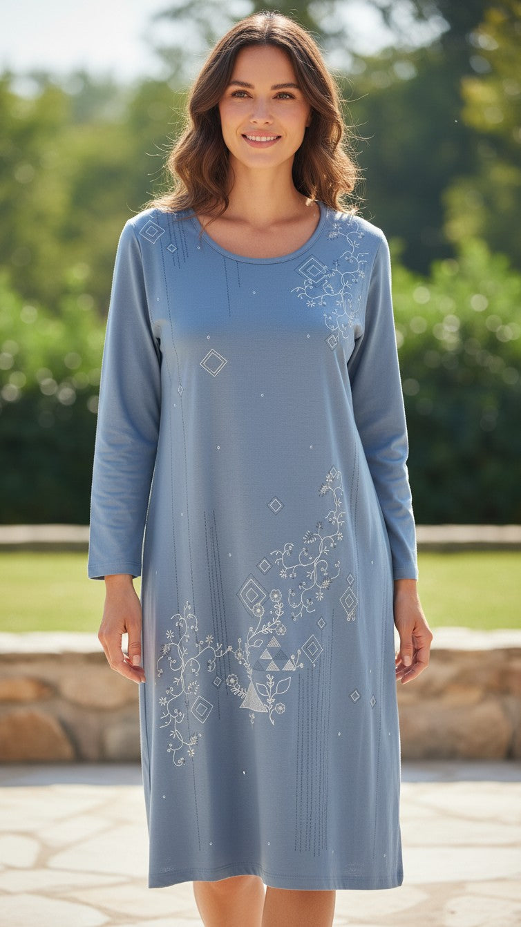 A woman wearing a Night Suits By Aaka blue long-sleeve tunic with delicate white floral and geometric embroidery.
