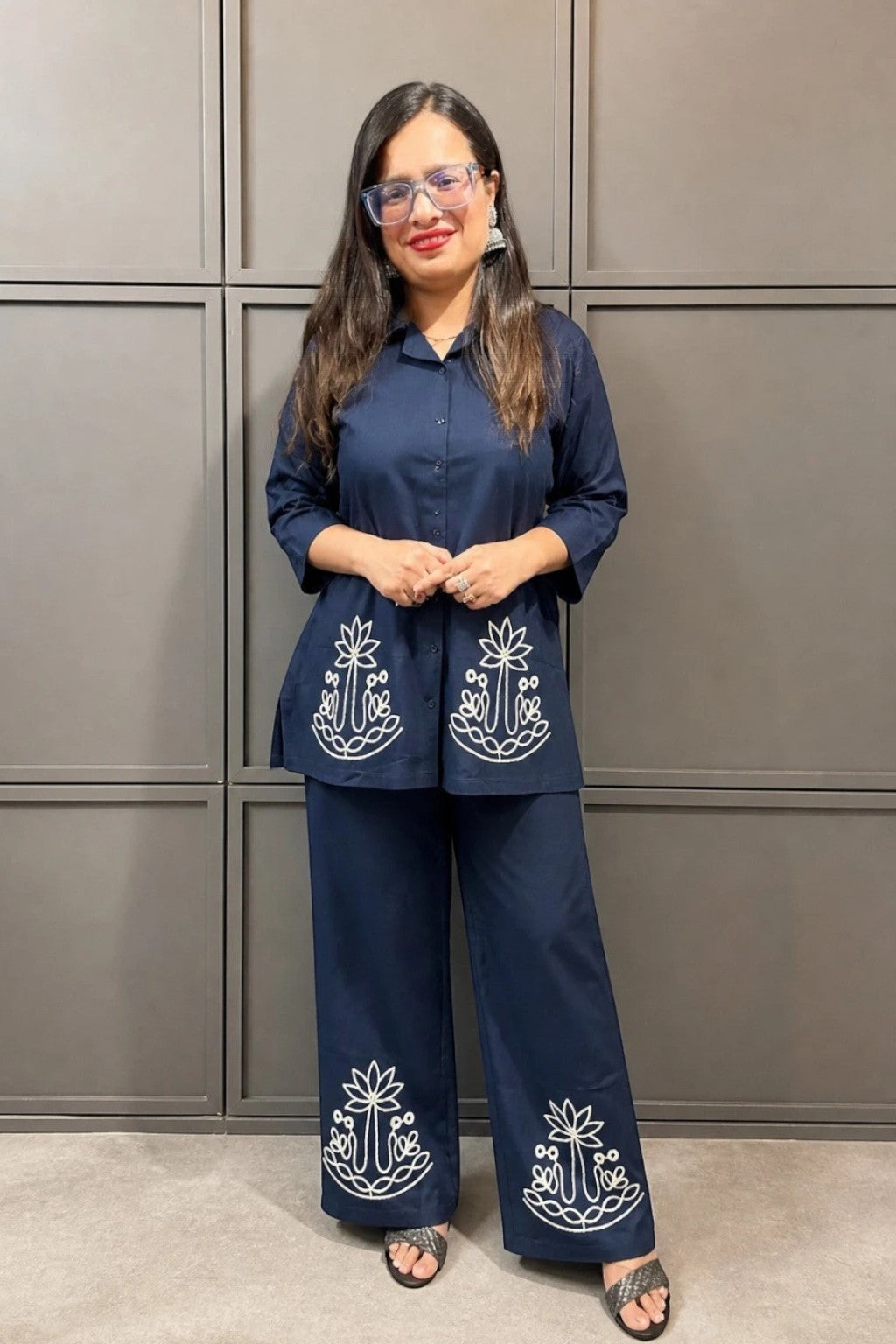 Night Suits By Aaka navy blue cotton hosiery coordset with white thread work on the shirt and wide-leg palazzo pants.