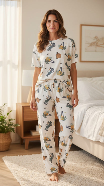Woman wearing a Night Suits By Aaka off-white printed pajama set with off-road vehicle and palm tree motifs
